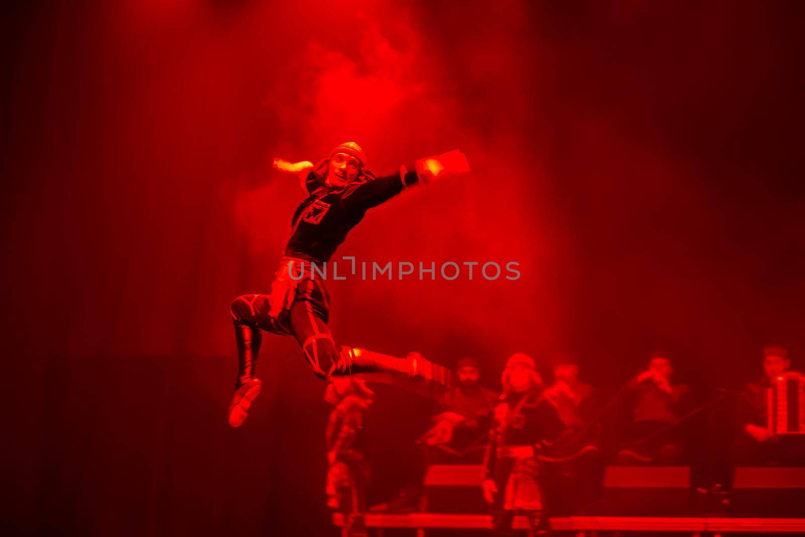 Belarus, Gomel, February 27, 2018. Concert hall. Speech of the national Georgian ballet Sukhishvili.The Georgian dancer jumped high while performing the dance on stage with a red light