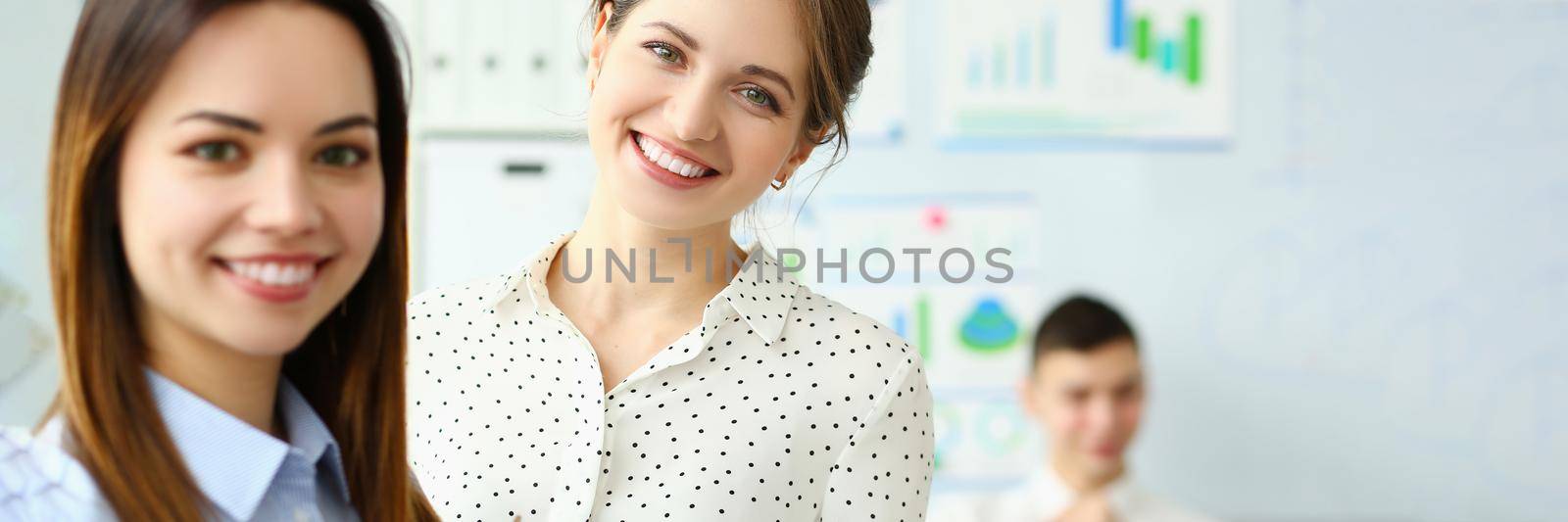 Portrait of smart female holding paper tablet with important business contract. Gorgeous lady in classy blouse looking at camera with great joy and calmness. Company meeting concept