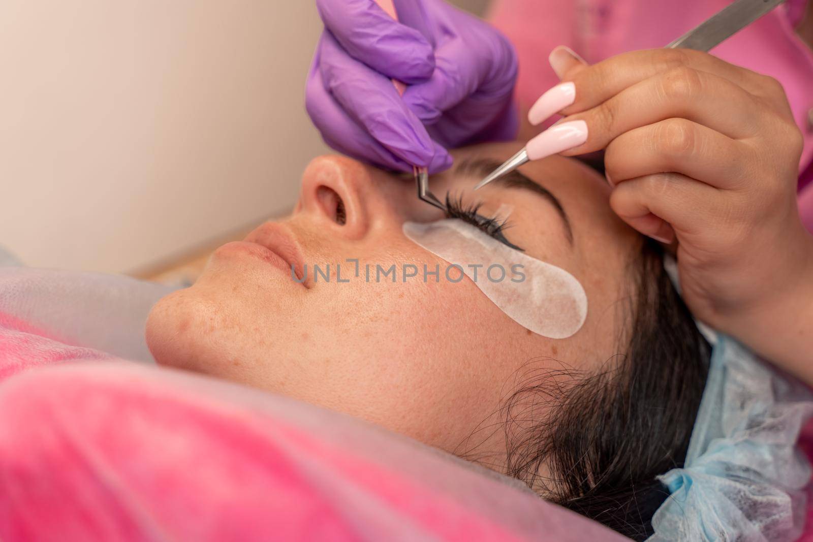 Eyelash extension procedure. Woman eye with long eyelashes. lashes, close up, macro, selective focus. by Matiunina