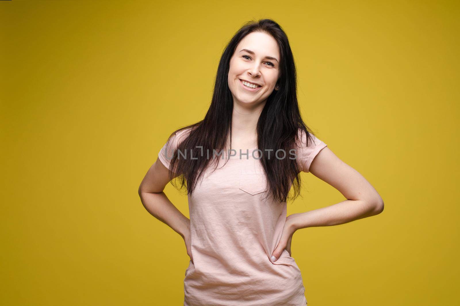 Slim woman wearing white shirt and jeans standing steady by StudioLucky