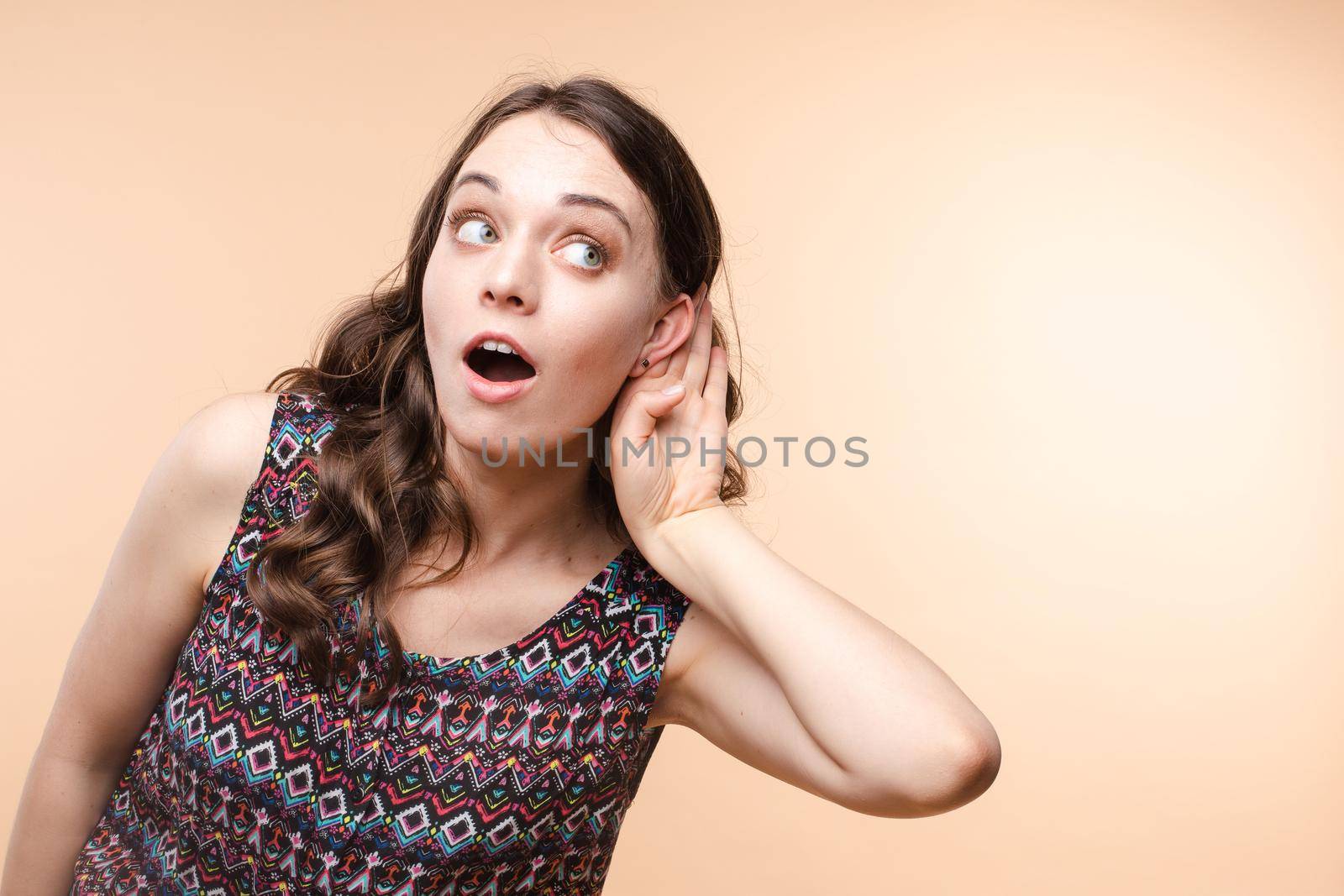 Charming girl listening to gossips. Studio portrait of beautiful caucasian by StudioLucky