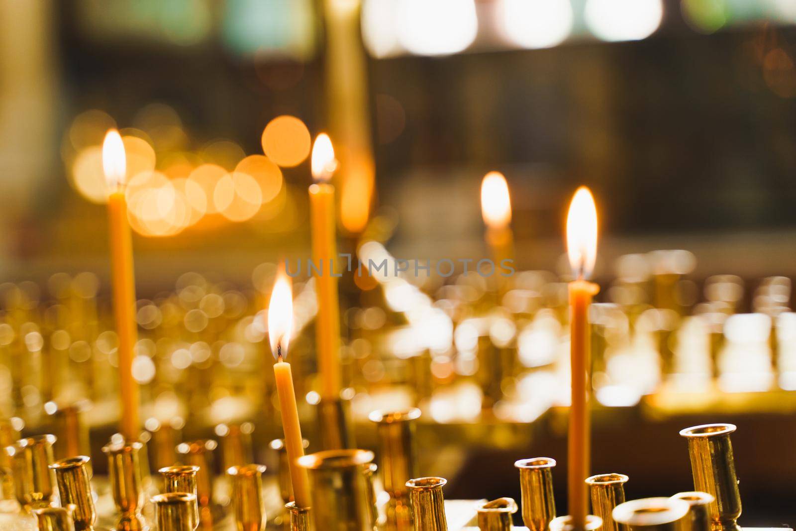 Many burning candles in church. Tragedy. Orthodox tradition and faith. Equipment for praying. Pray for people life. Pray to god