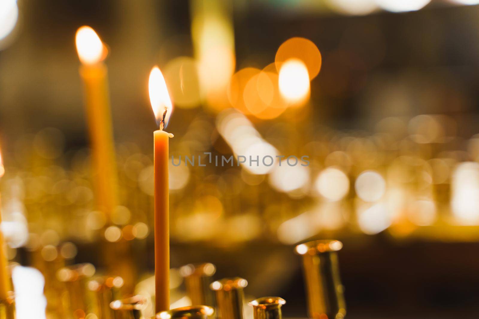 Many burning candles in church. Tragedy. Orthodox tradition and faith. Equipment for praying. Pray for people life. Pray to god