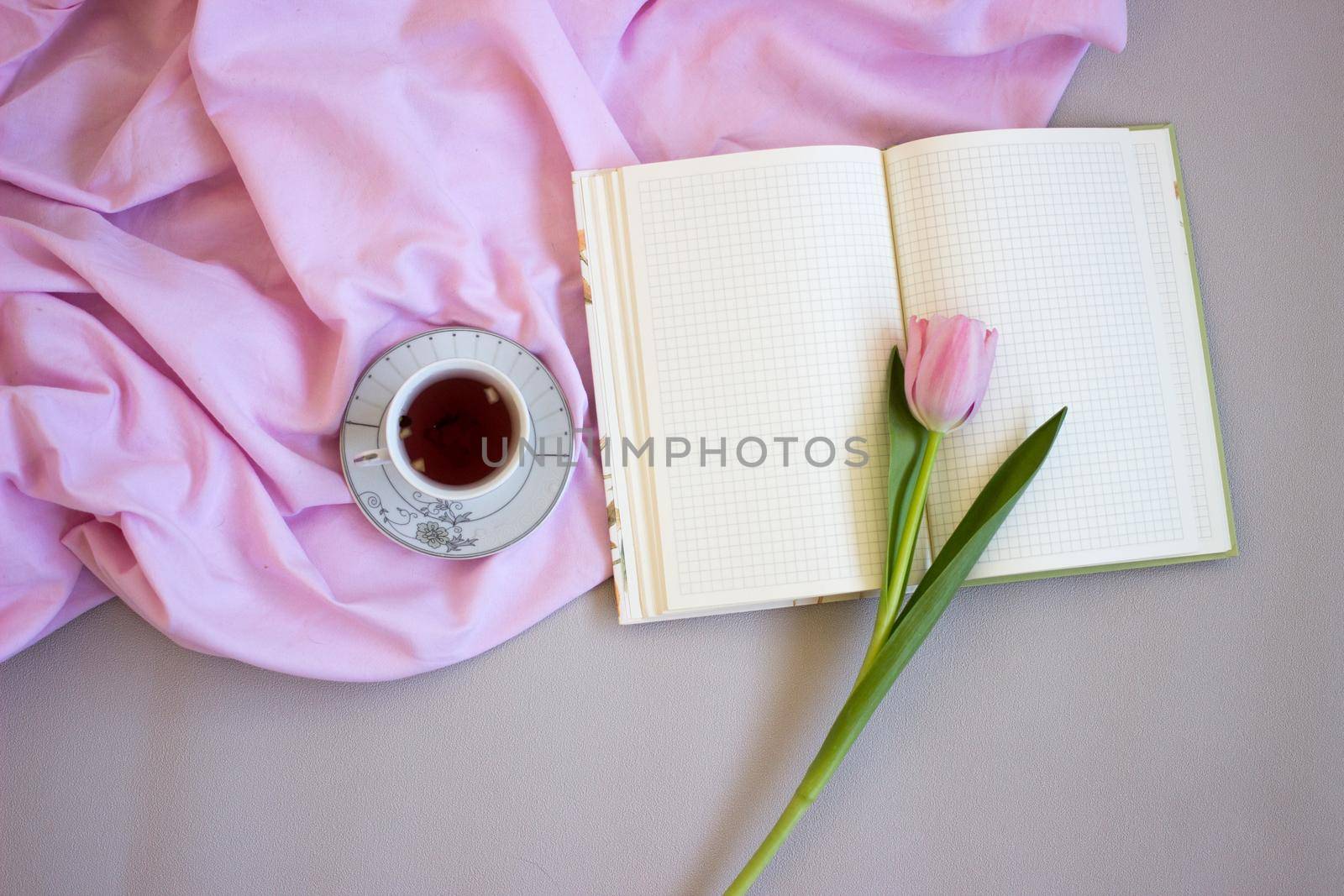 Pink tulips on wooden background. Open book, craft gift box and coffee. Mothers Day, Women Day, floral desing by KatrinBaidimirova