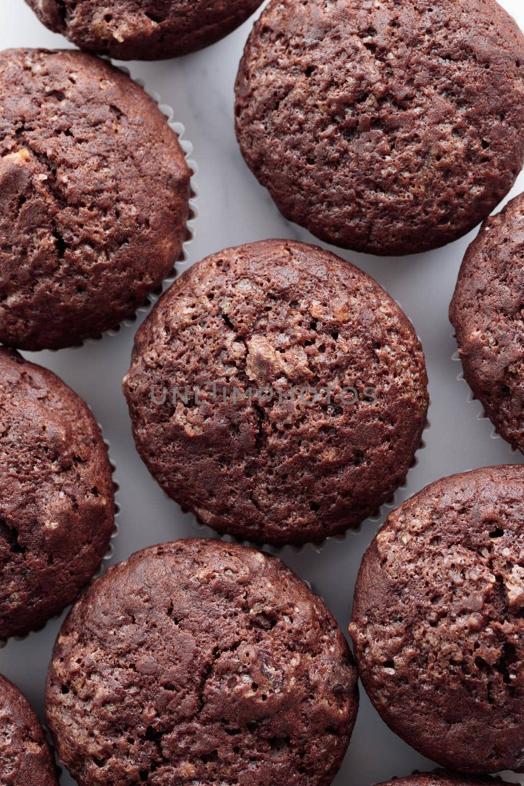 Pile of chocolate muffins on a white background