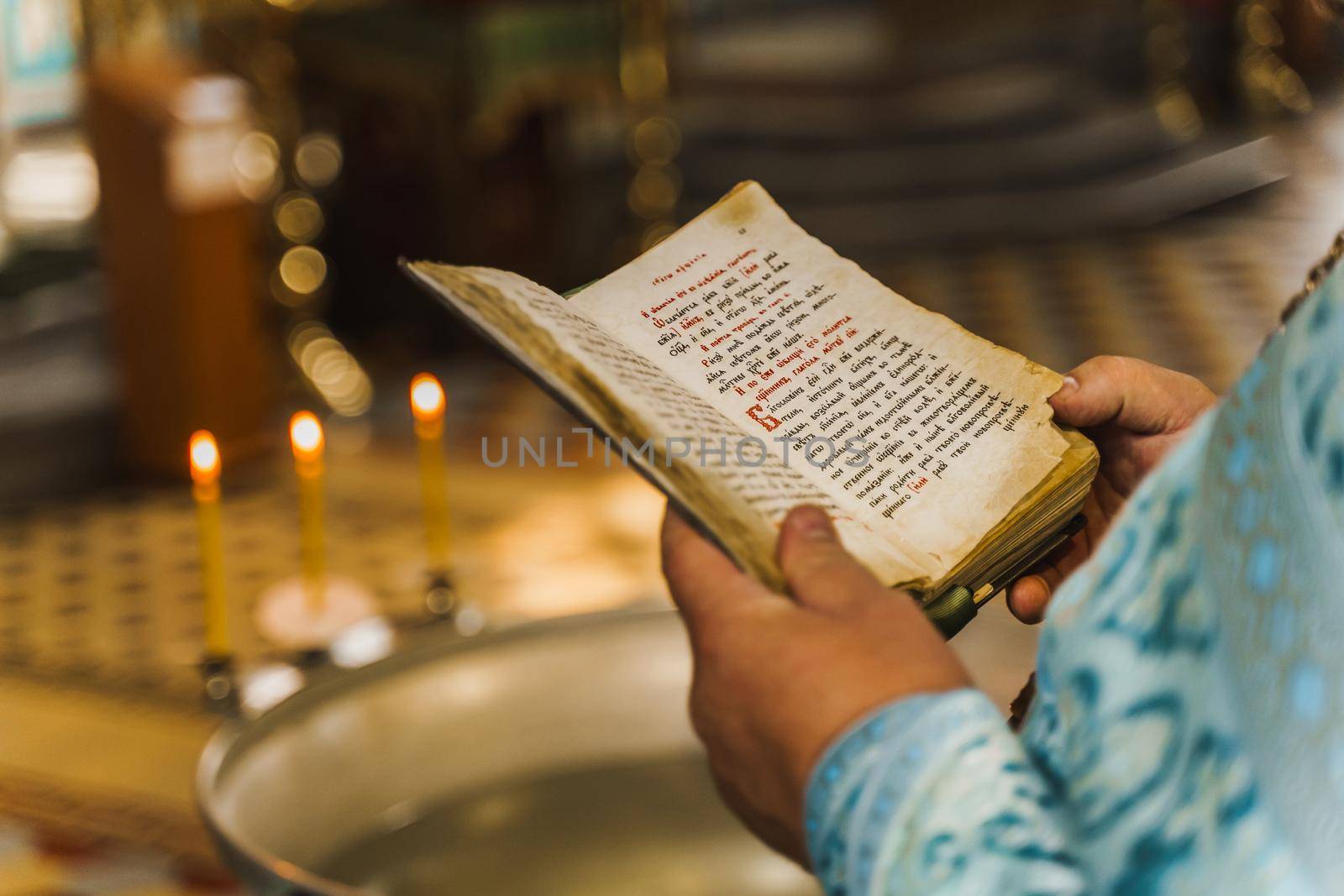 Holy book opened in priest hands in church. Priest reads pray. Orthodox faith. Equipment for praying. Pray for people life. Pray to god