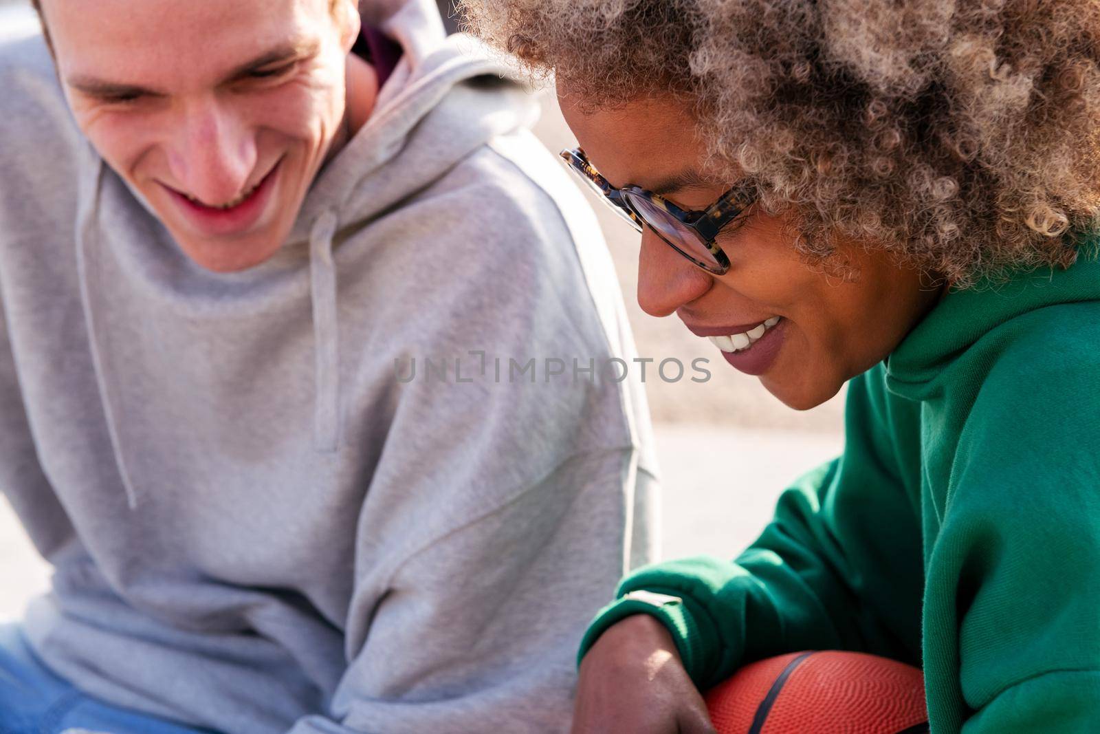 close-up portrait of a young latin woman smiling with a caucasian friend, concept of lifestyle and friendship