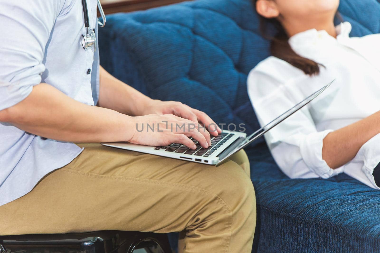 Psychologist Doctor using laptop to note and typing patient symptom detail and treatment during consulting to online research for best solution from internet.
