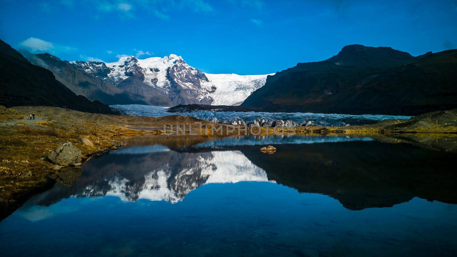 Glaciers and mountains reflected in lake