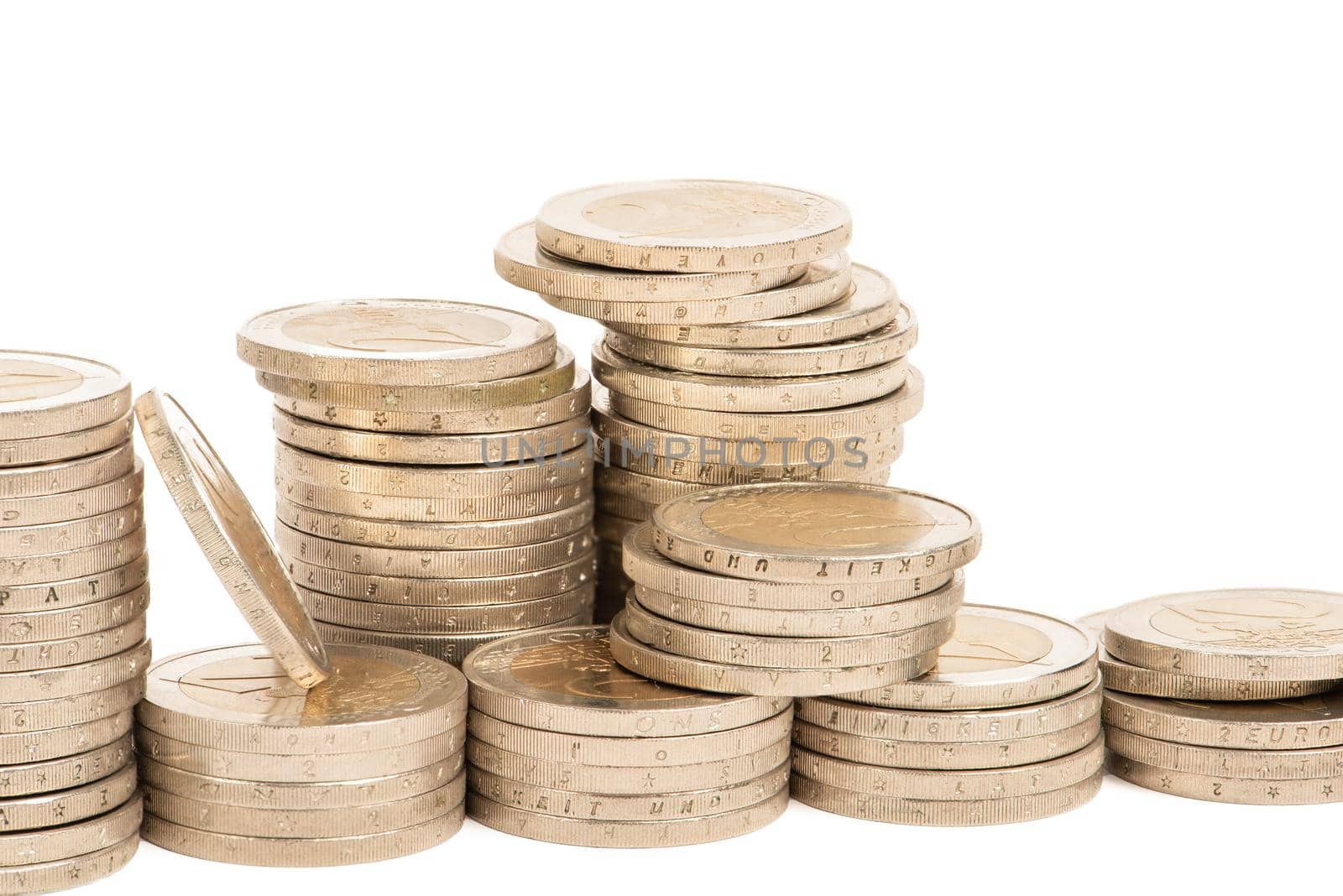 Stacks of coins on a white isolated background. 2 euro coins in a stack