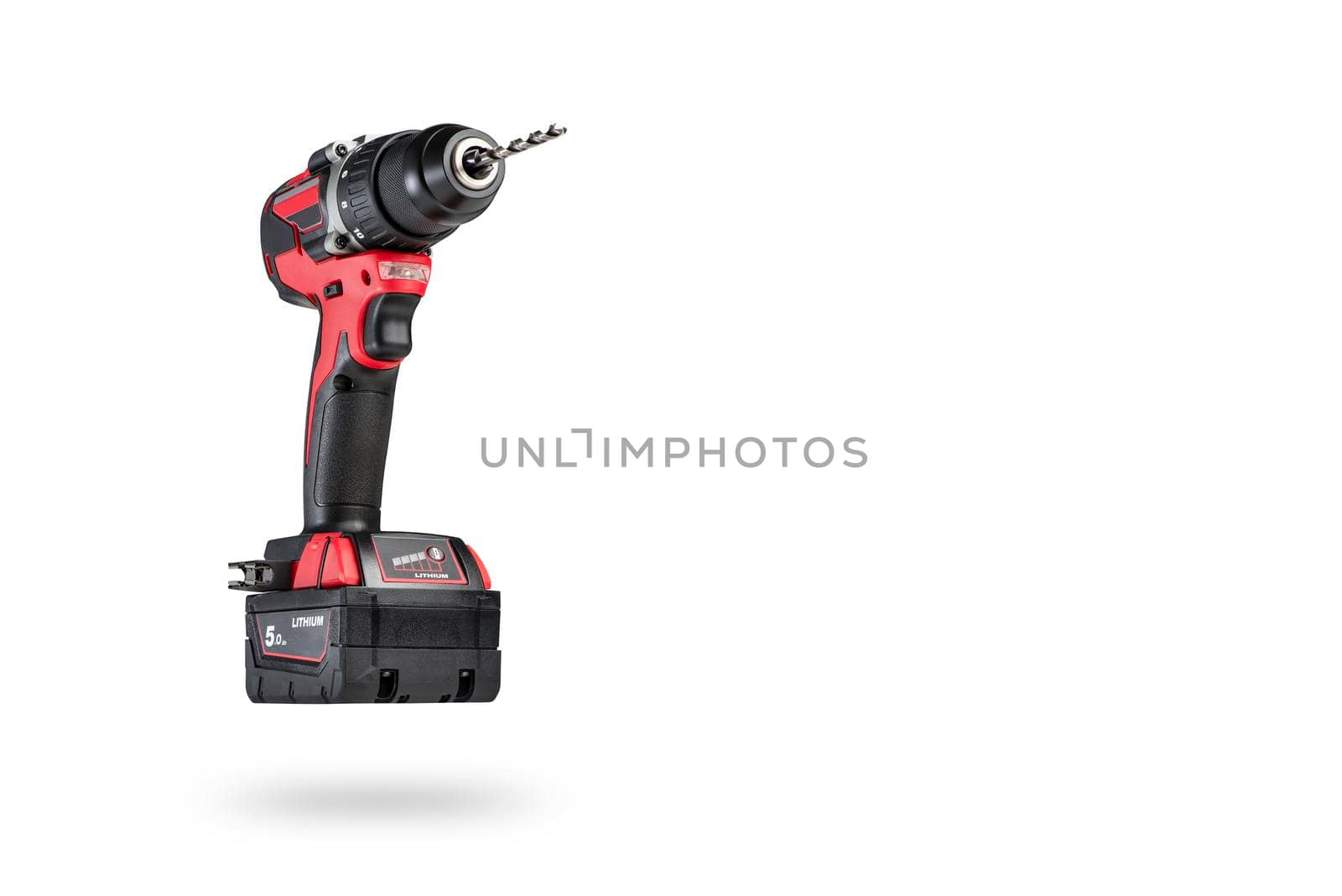 cordless tool isolated on white background. Cordless screwdriver with a drill inserted into the chuck and an extra battery on a white background