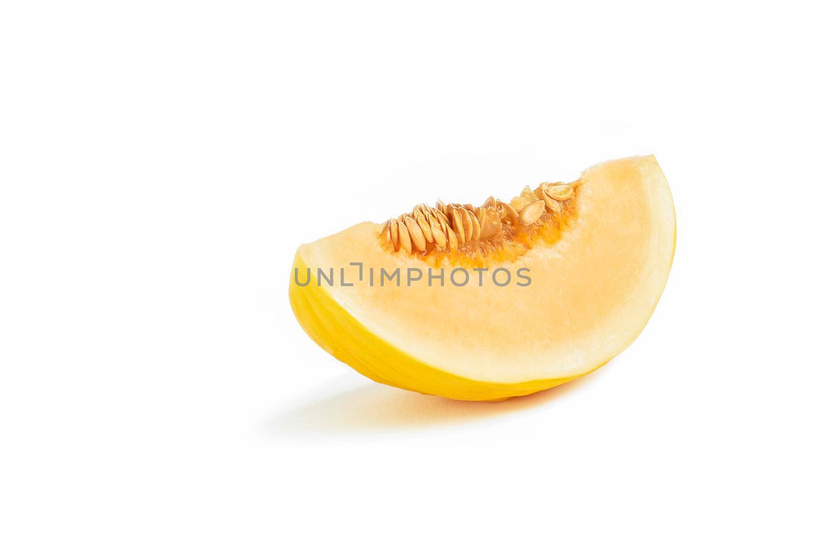 Melon on a white background. Yellow melon on a white isolate. Fresh juicy piece of melon with shadow on a white background. For insertion into a project, design or advertisement.