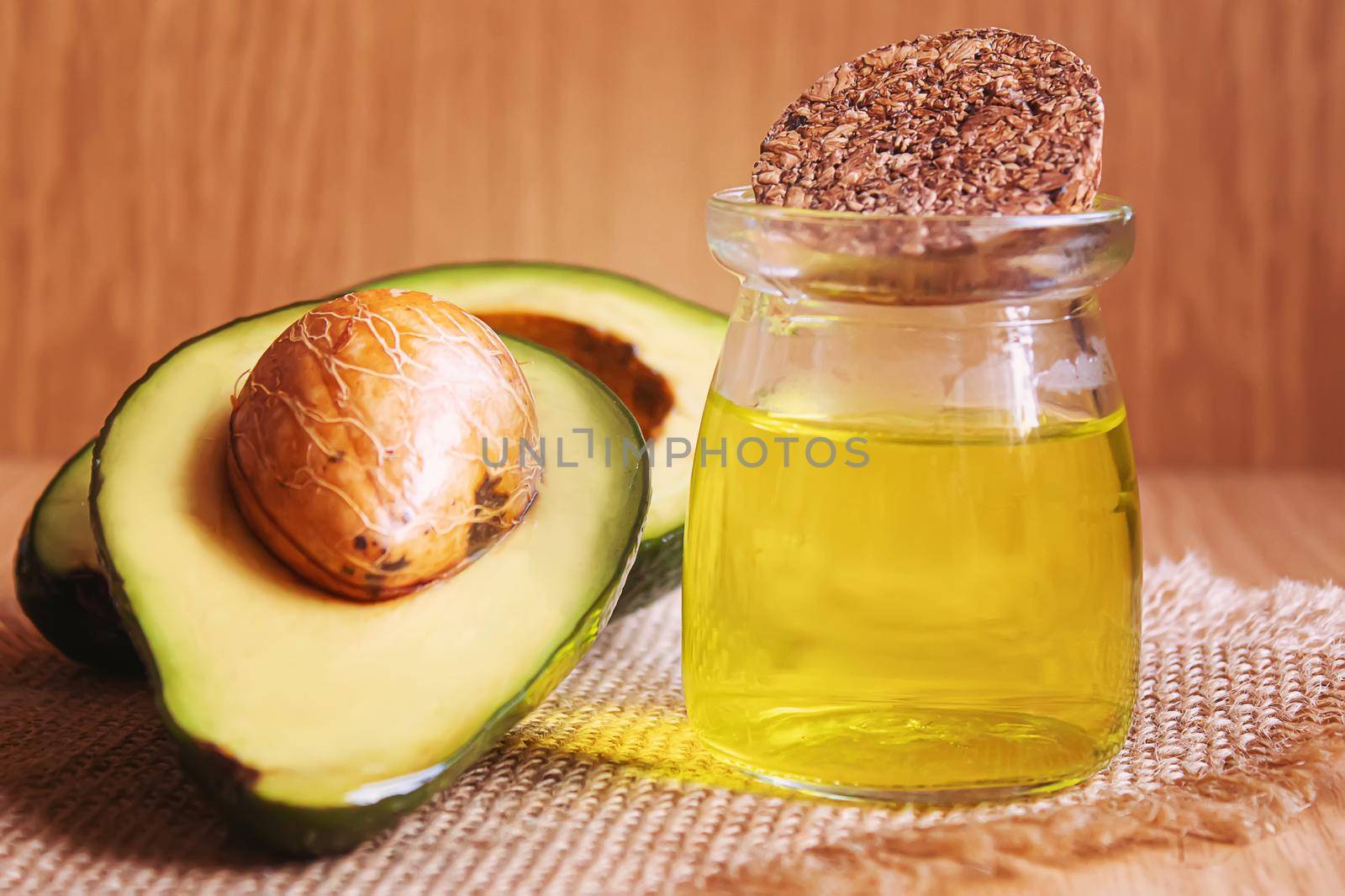 Avocado and avocado oil on wooden background. Selective focus.food