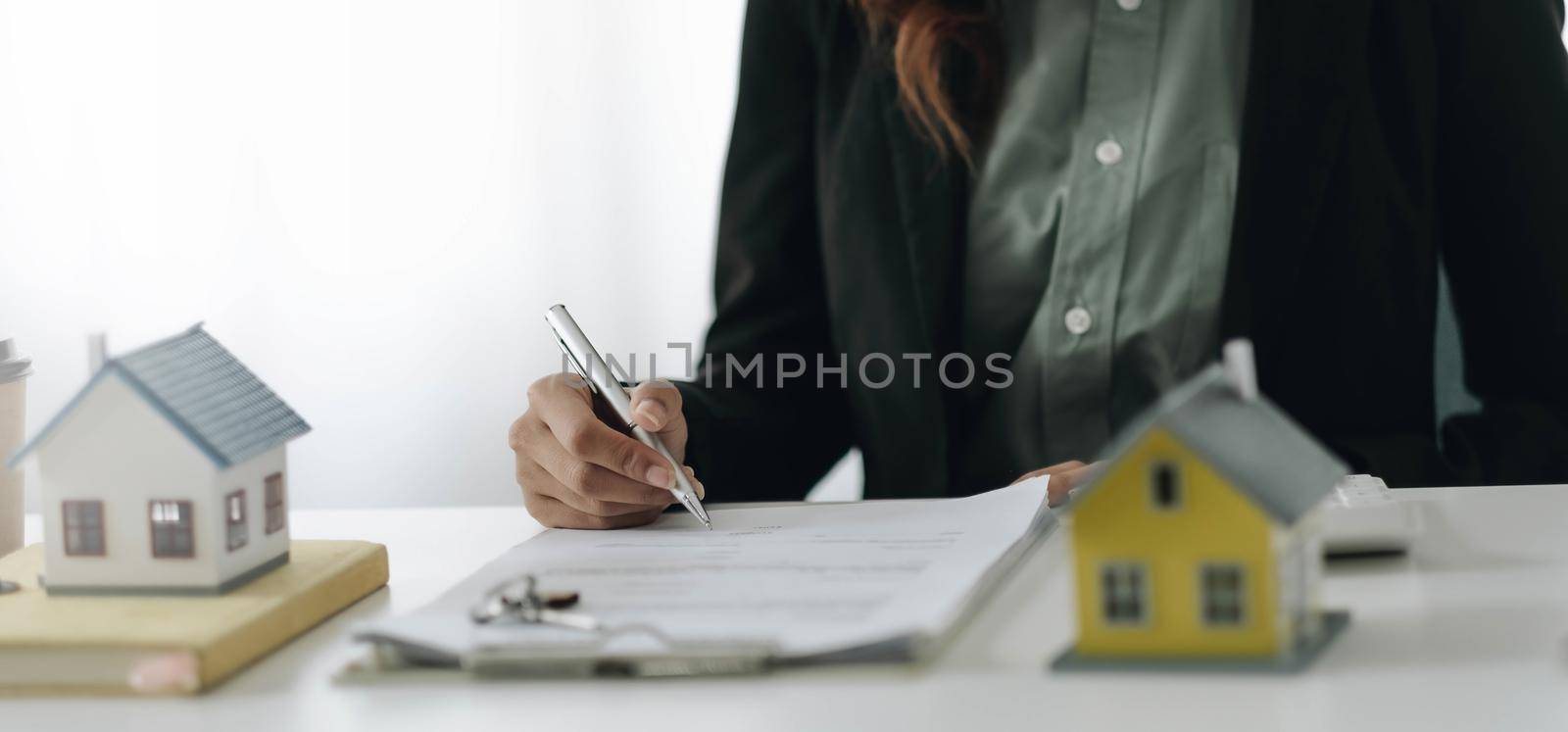 Estate agent broker presentating to client decision signing agreement contract real estate with approved mortgage application, buying mortgage loan offer for and house insurance..