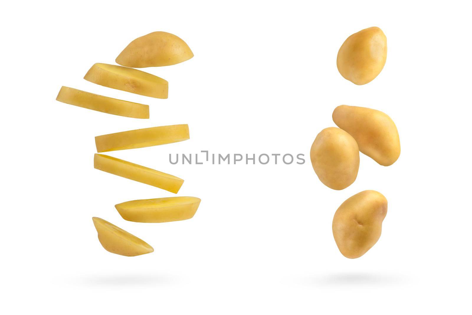 Fresh unpeeled potatoes, isolated on white background. Big set flying potatoes on a white isolated background casts a shadow. by SERSOL