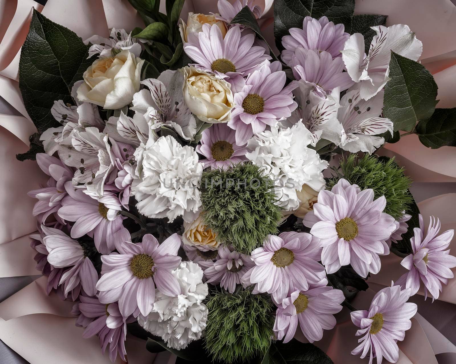 Beautiful chrysanthemums, carnations, roses and other flowers in a bouquet close-up. Top view.