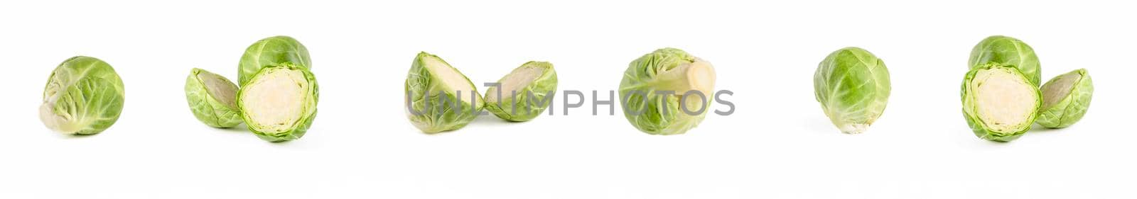 Brussels sprouts. Large set of fresh brussels sprouts in stacks on a white isolated background. Deep focus stacking. by SERSOL