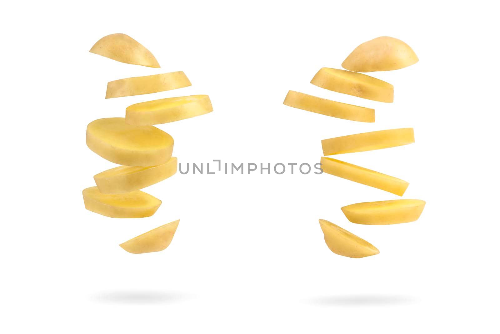 Fresh unpeeled potatoes, isolated on white. Big set flying potatoes on a white isolated background casts a shadow. A slice of fresh potatoes falls on a white background.