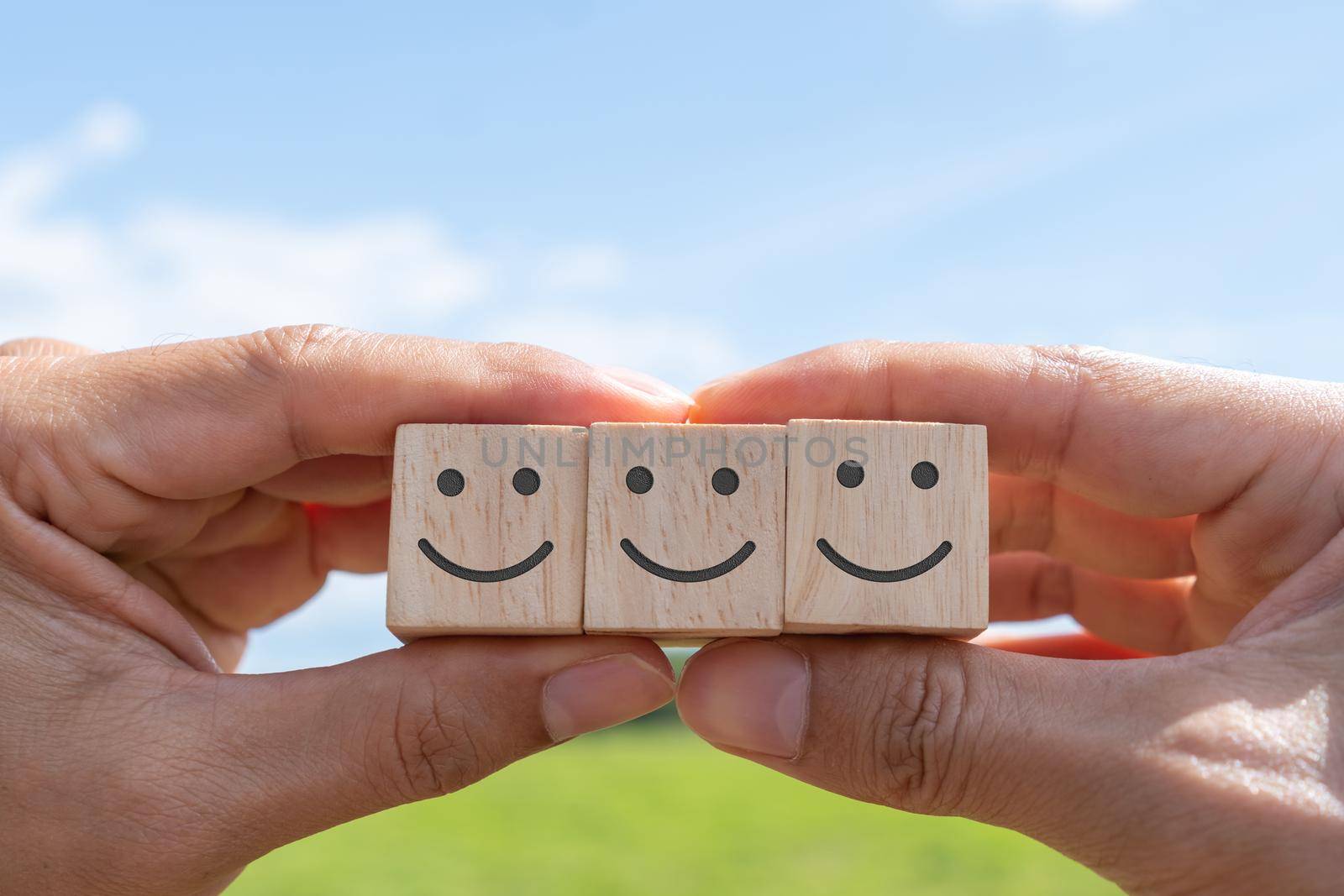 Smile face and cart icon on wood cube. Optimistic person or people feeling inside and service rating when shopping, satisfaction concept in business.