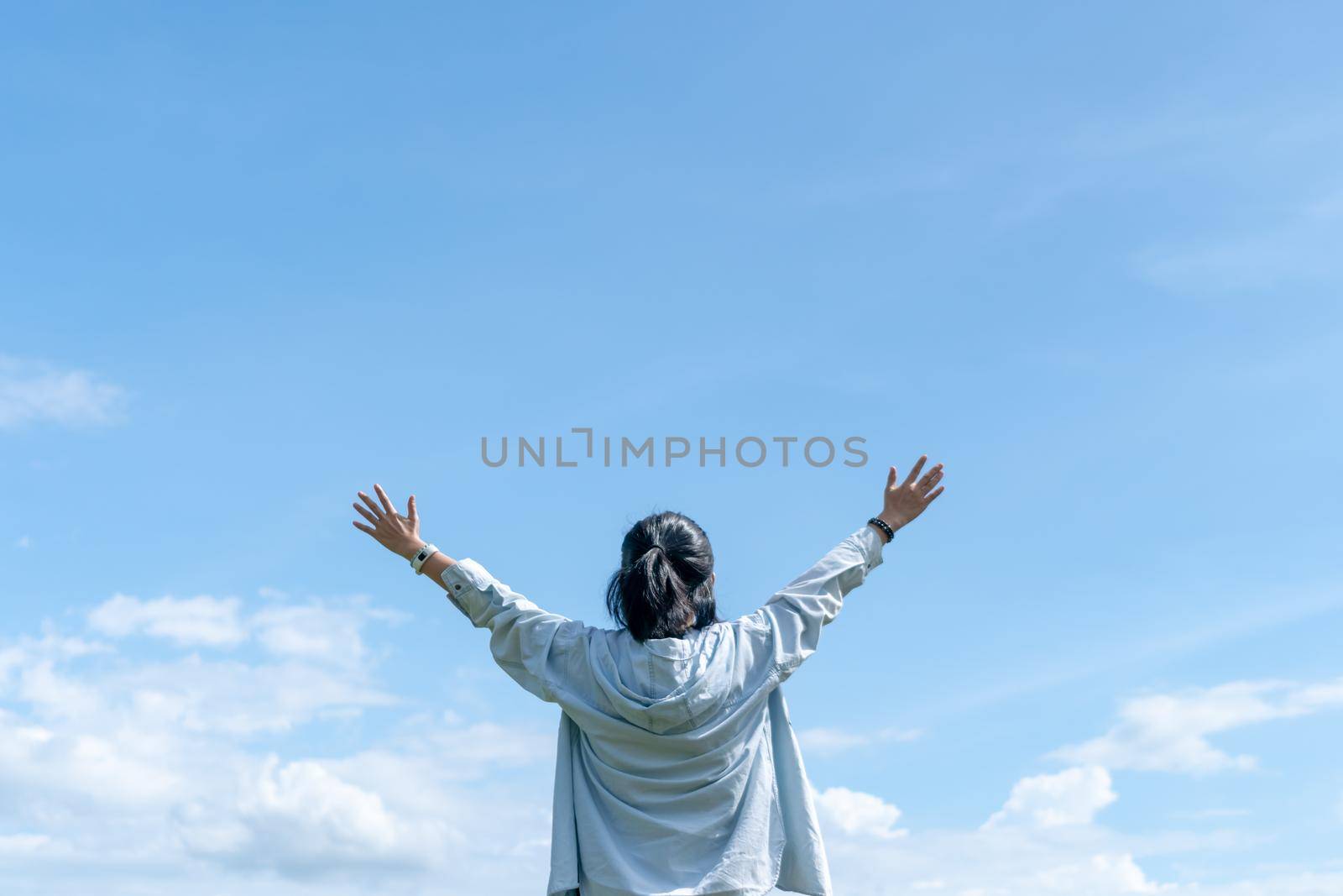 Copy space freedom lady hand rising up summer vacation and freedom concept blue sky and mountain in abstract summer background. Vintage clean color tone style 