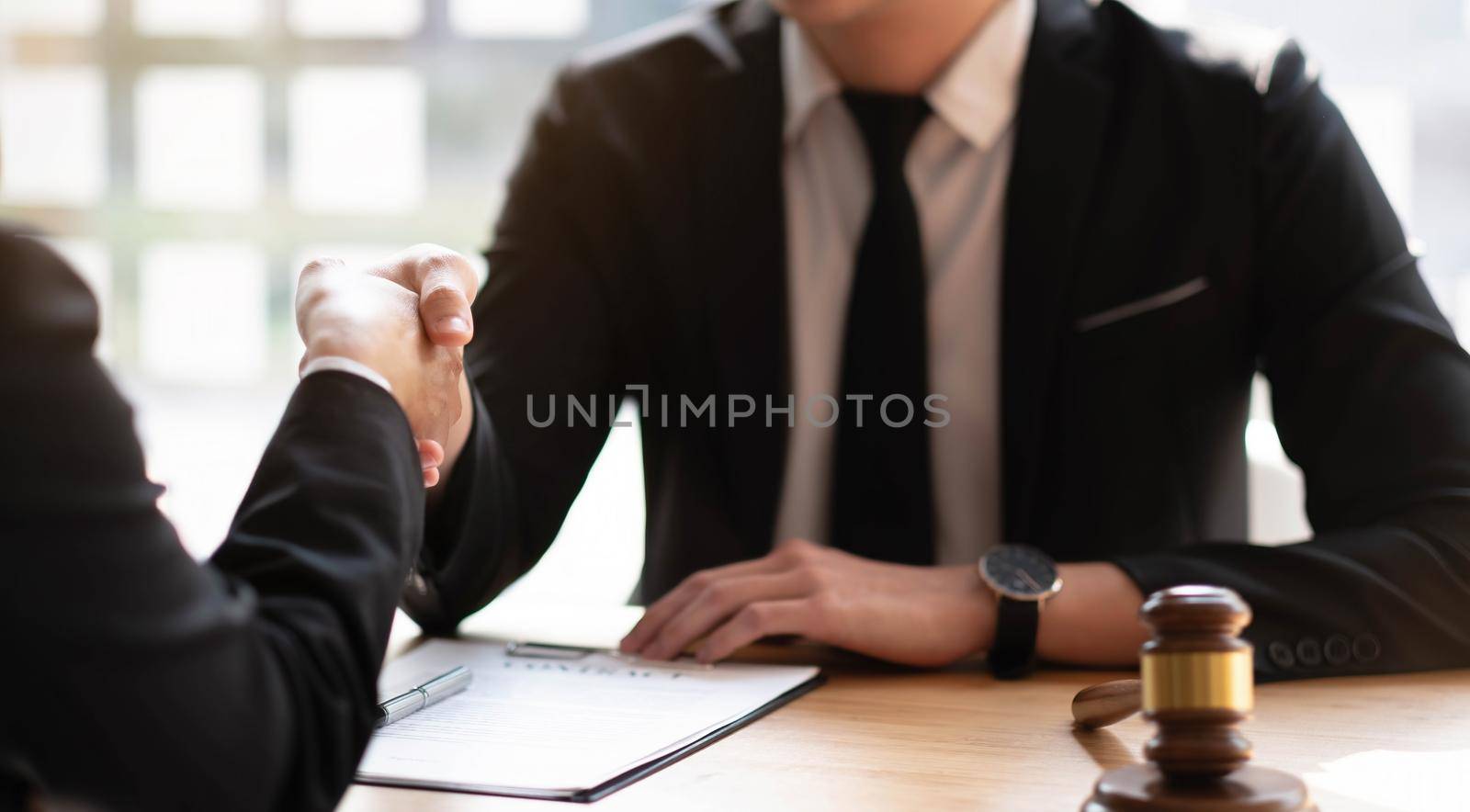 Business lawyer and partnership consult and meeting concept. Image businessmans handshake. Successful businessmen handshaking after good deal. meeting concept. by wichayada