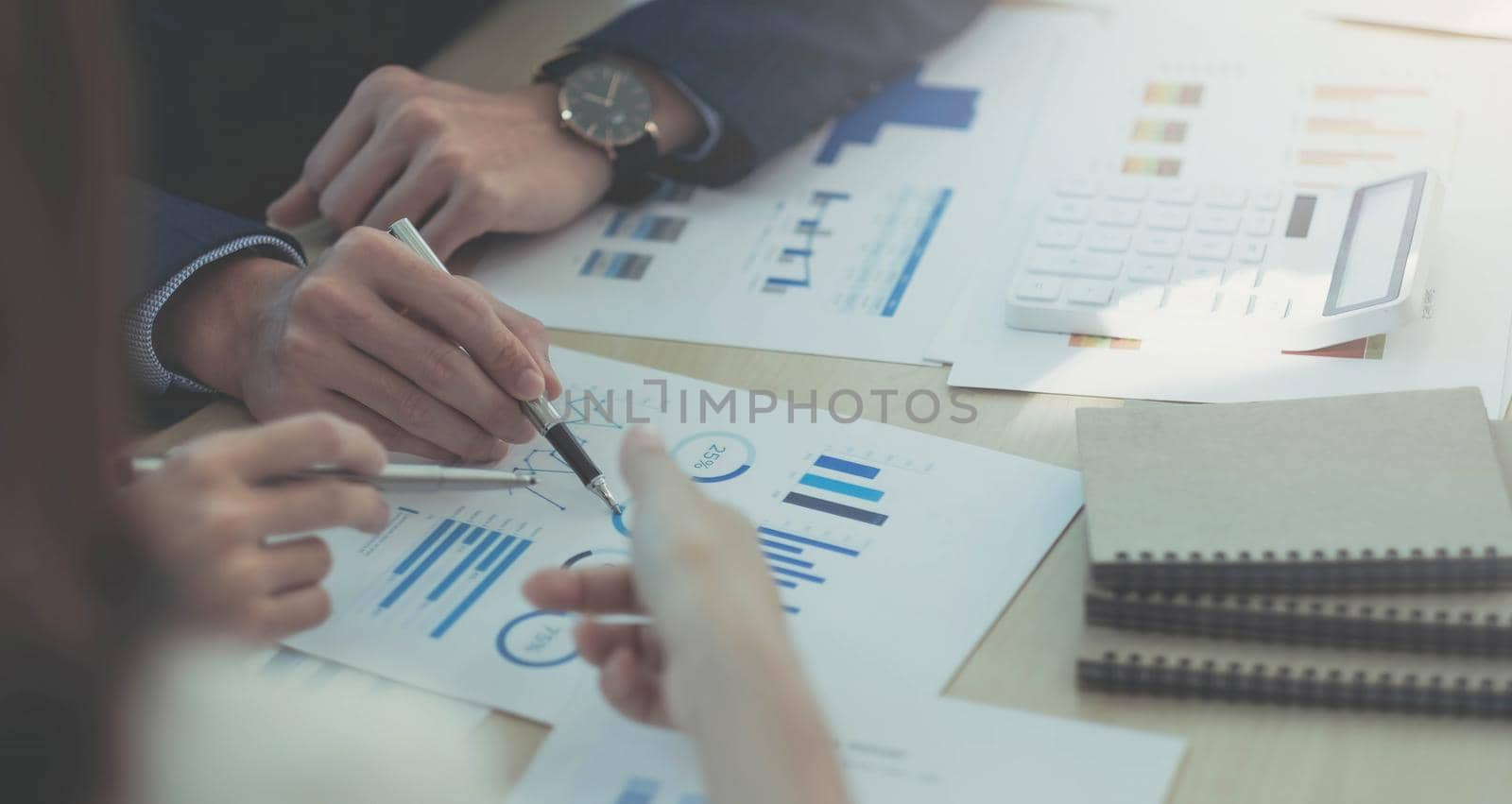 Business People Talking Discussing with coworker planning analyzing financial document data charts and graphs in Meeting and successful teamwork Concept by wichayada