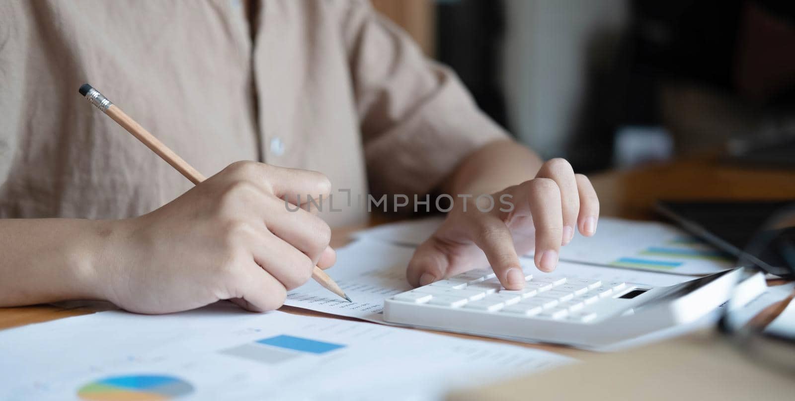 Close up woman financial inspector and secretary making report calculating balance. Internal Revenue Service checking document.