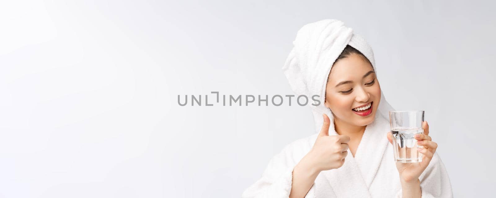 Healthy young beautiful woman drinking water, beauty face natural makeup, isolated over white background