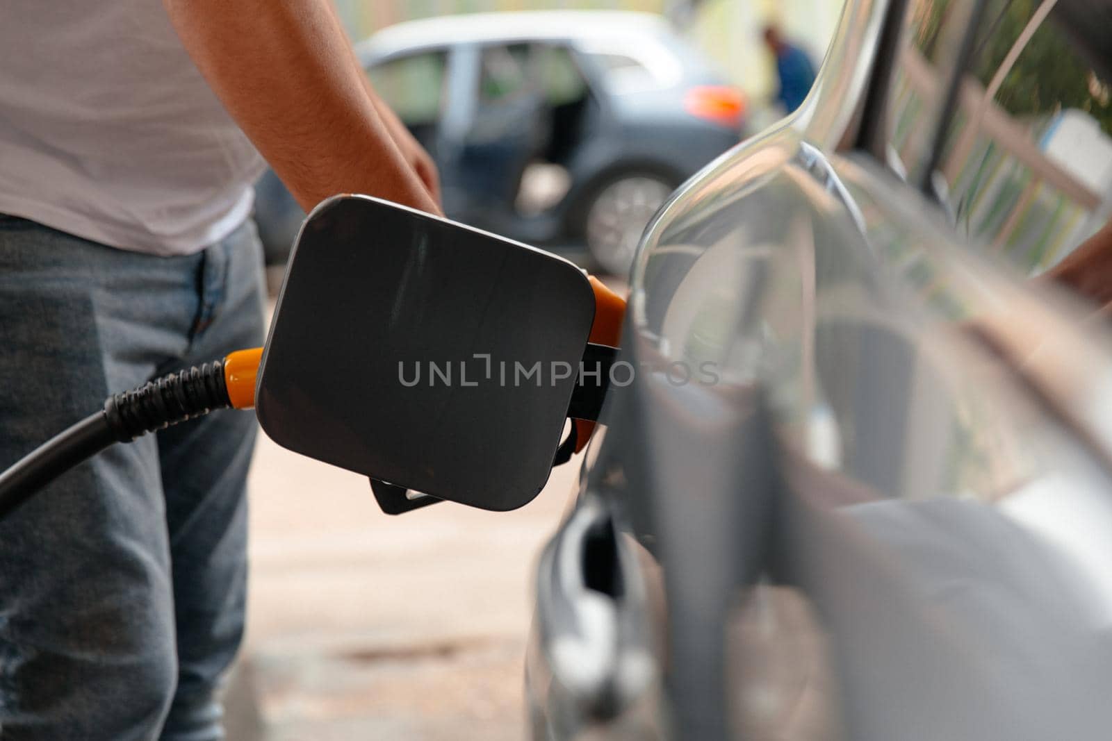 Refuel cars at the fuel pump. The driver hands, refuel and pump the car's gasoline with fuel at the petrol station. Car refueling at a gas station Gas station