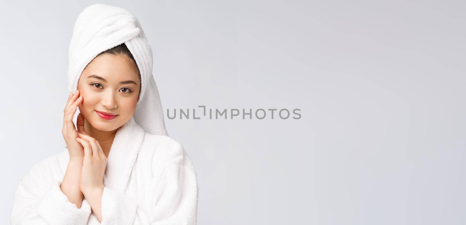 Spa skincare beauty Asian woman drying hair with towel on head after shower treatment. Beautiful multiracial young girl touching soft skin