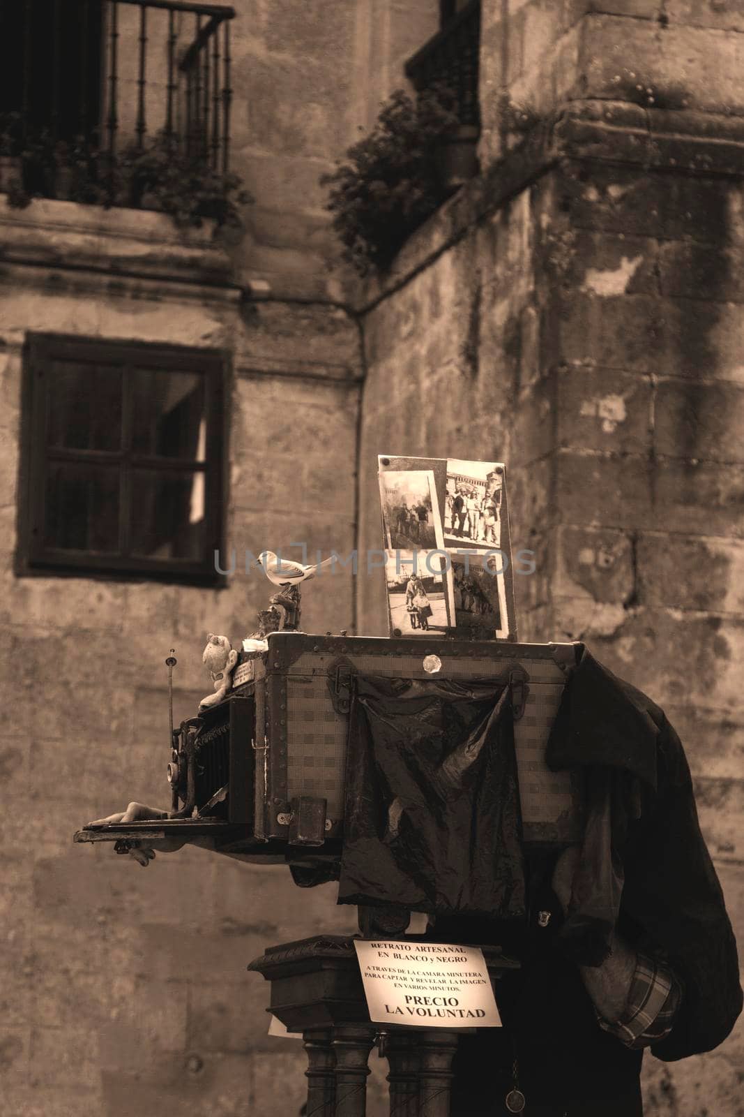 Photographer using an antique camera in an old town in black and white