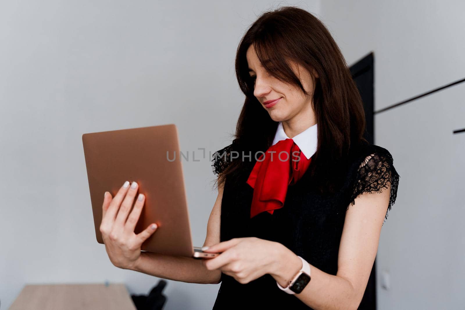 Teacher with laptop on white background. . Foreign school private study with a school girl. Teacher explain grammar of native language using laptop.