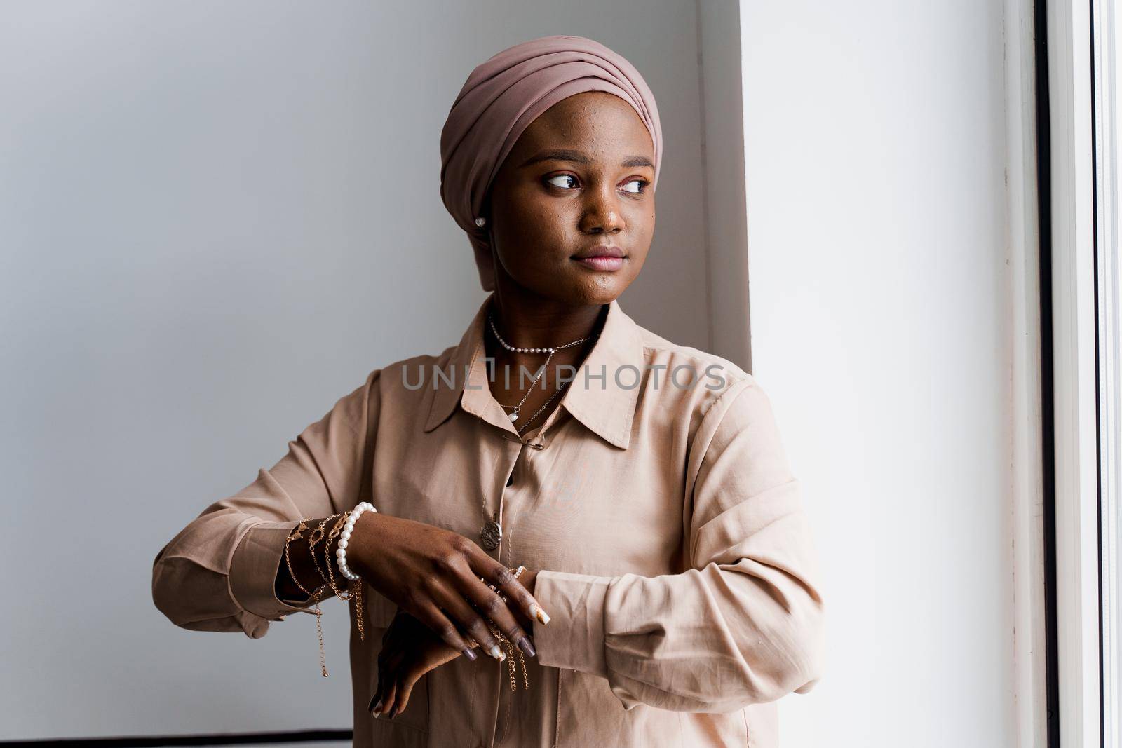 Muslim black girl on white background. African business woman in studio. Model posing. Advert for banking and islamic social media
