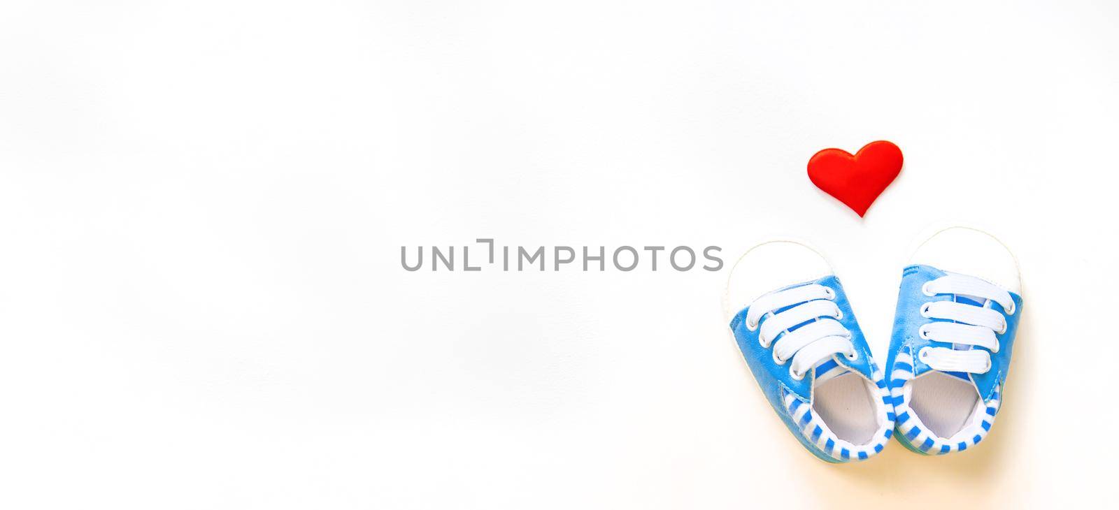 baby booties and heart isolate on a white background. Selective focus.