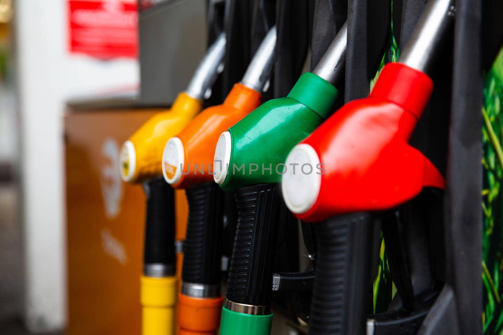 Detail of a petrol pump in a petrol station. Blue, green, red, golden colors. by RecCameraStock