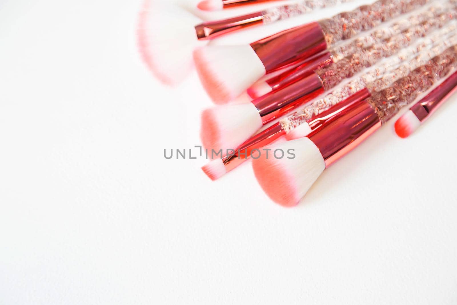 Makeup brushes on a white background. Selective focus.