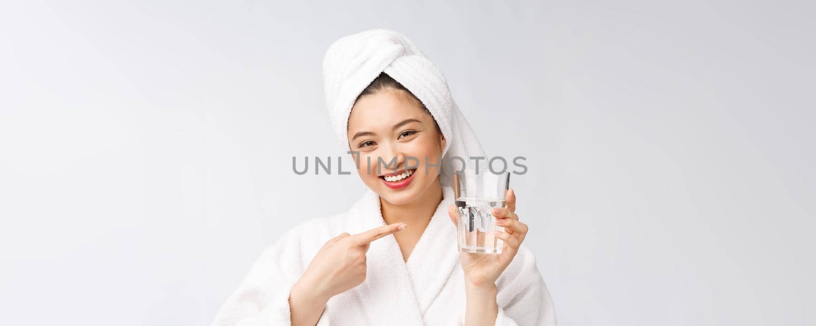 Healthy young beautiful woman drinking water, beauty face natural makeup, isolated over white background. by Benzoix