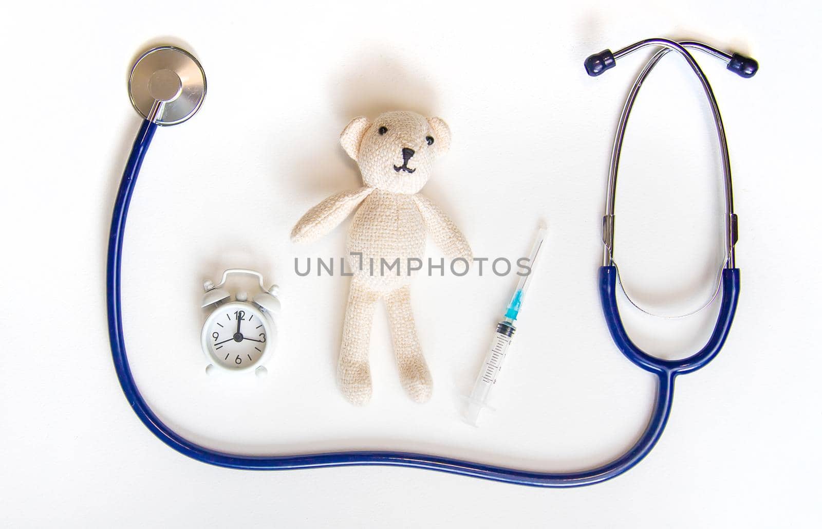 Teddy bear stethoscope and syringe isolate on a white background. Selective focus.