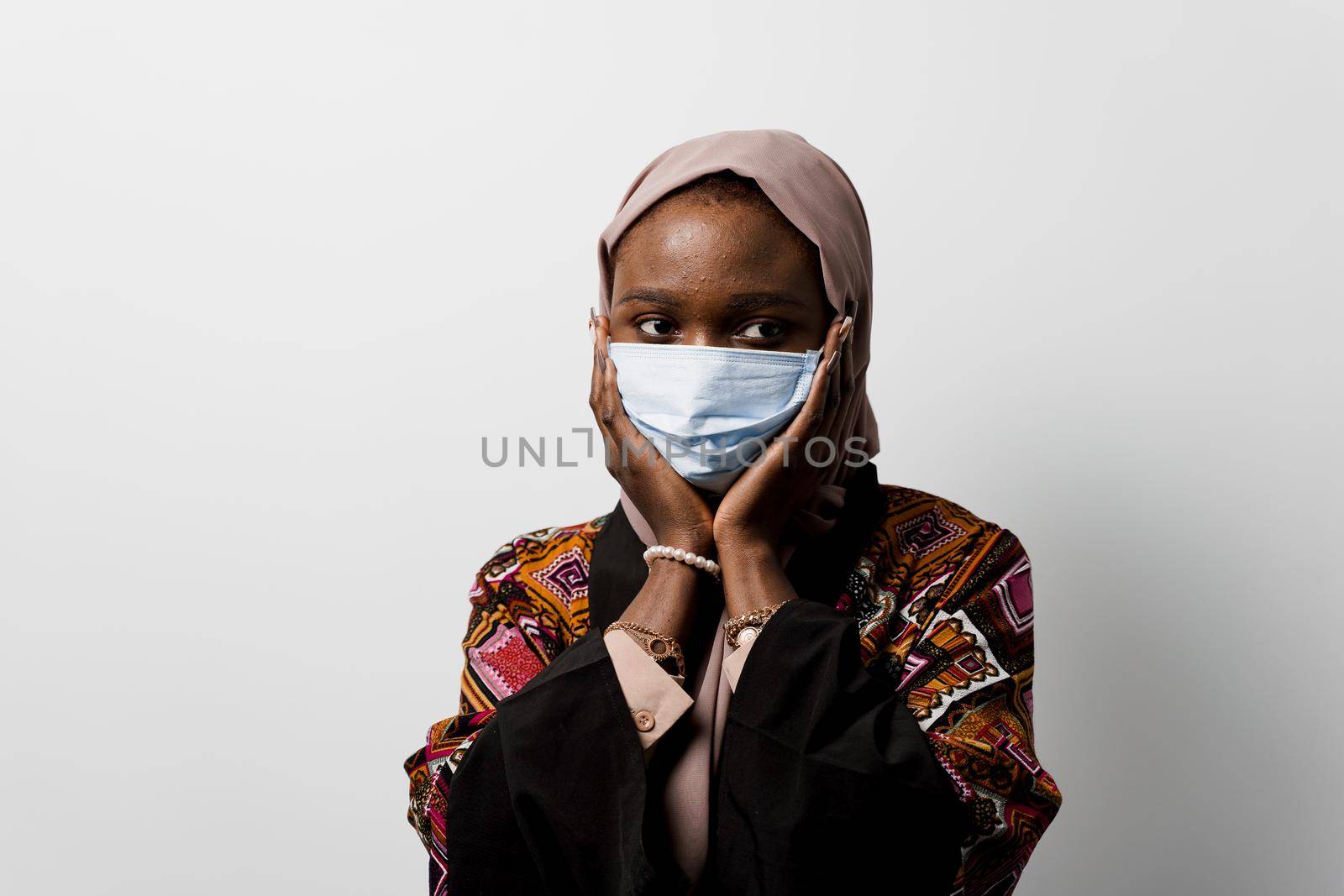 Black muslim business woman in medical mask weared in hijab on white backgroud. Cryptocurrency investments in bitcoin. Successful black girl.