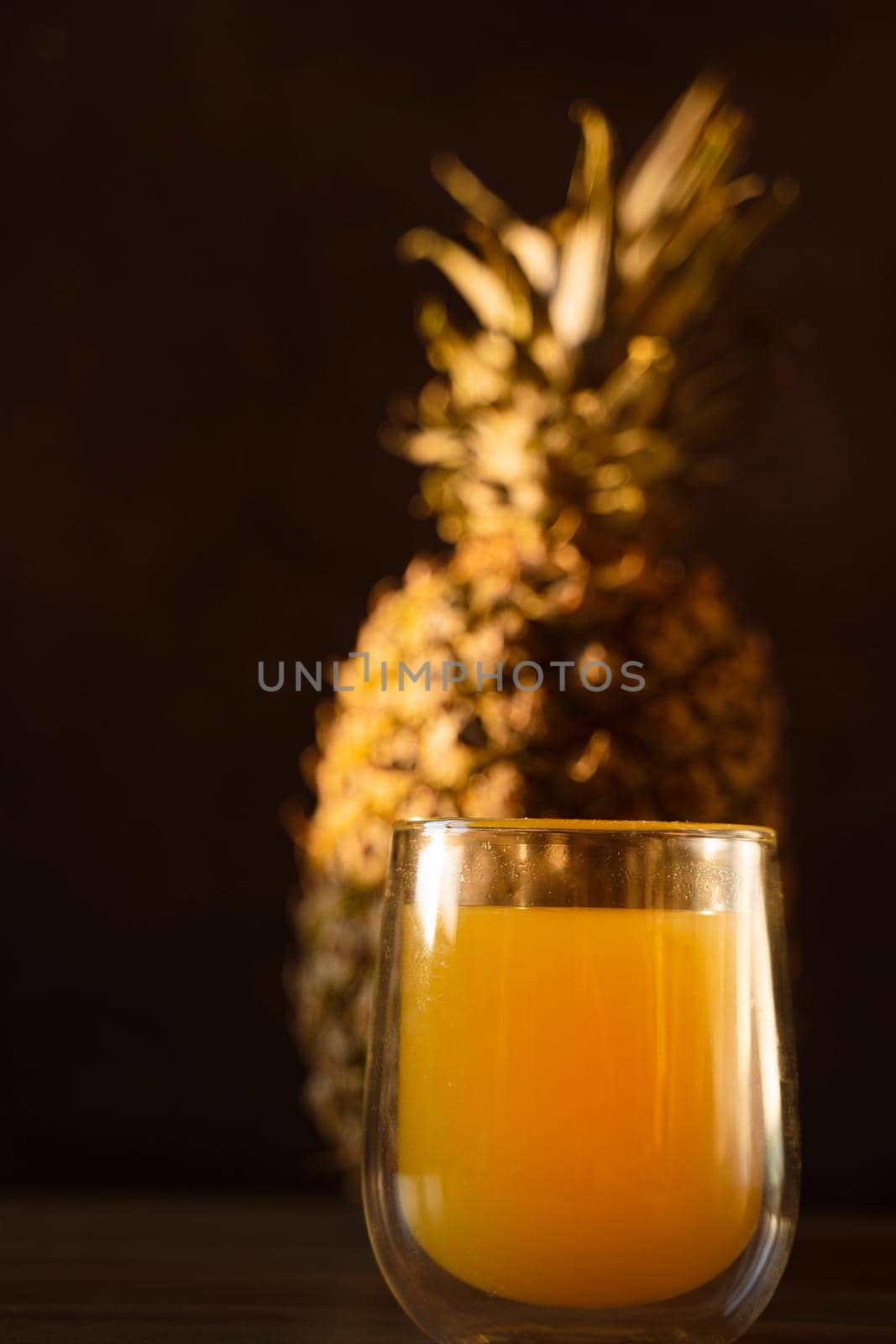 Pineapple fruit and juice in double glass cup. Tropical fruit . Pouring yellow tropical juice into glass.