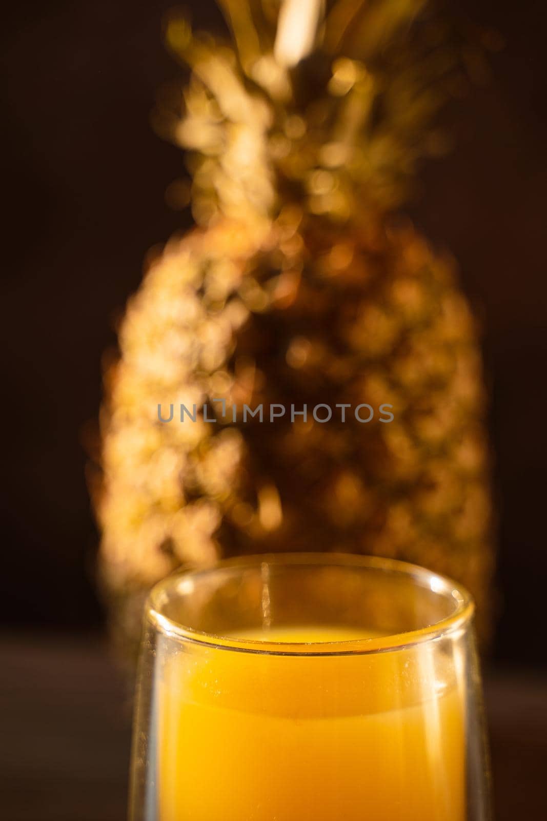 Pineapple fruit and juice in double glass cup. Tropical fruit . Pouring yellow tropical juice into glass.