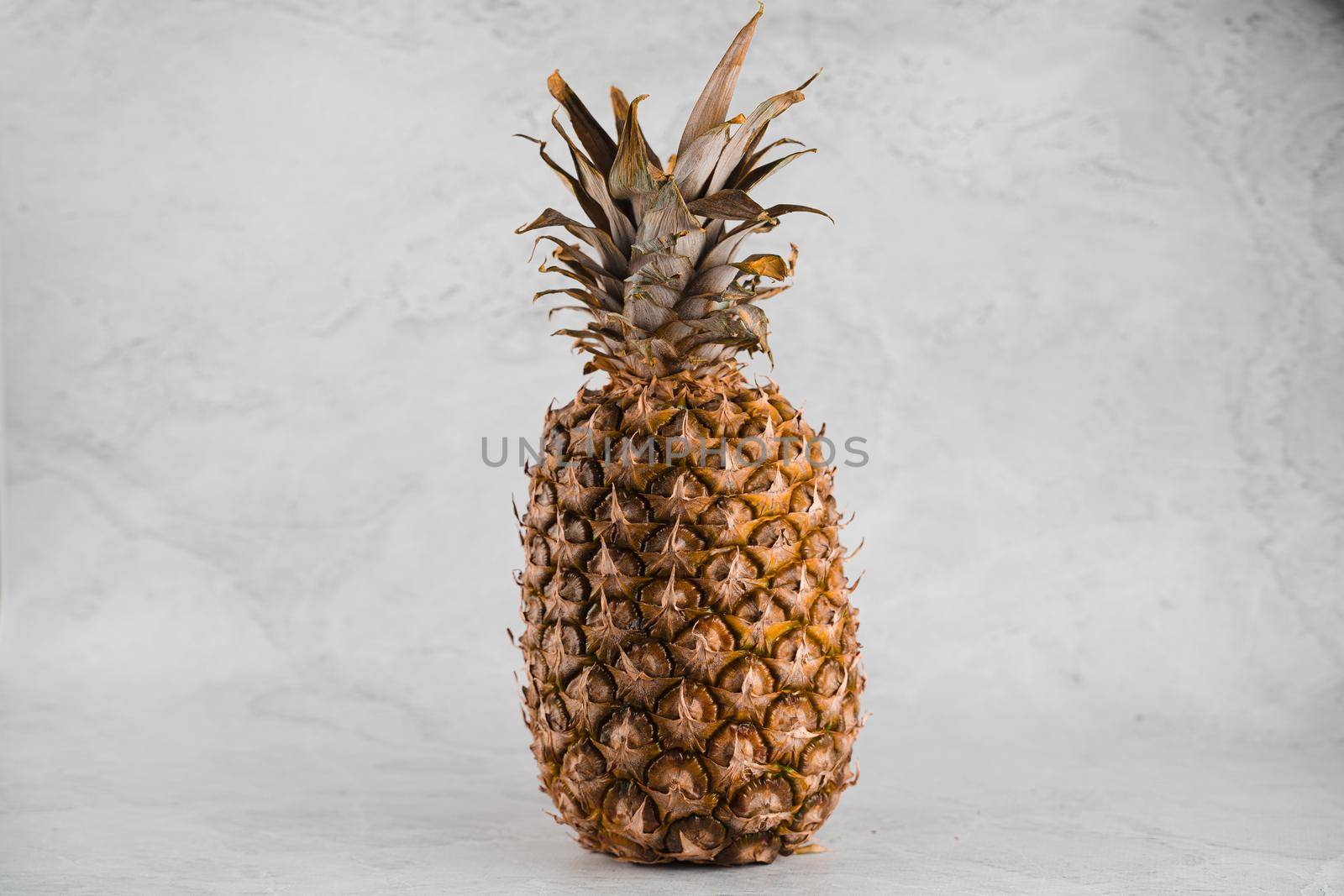 Pineapple tropical fruit on white stone background background. Citrus fruit with vitamin c for helth care