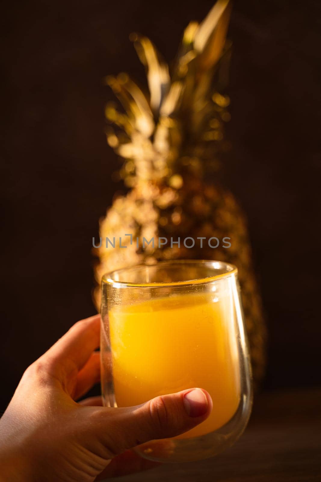 Pineapple fruit and juice in double glass cup. Tropical fruit . Pouring yellow tropical juice into glass.