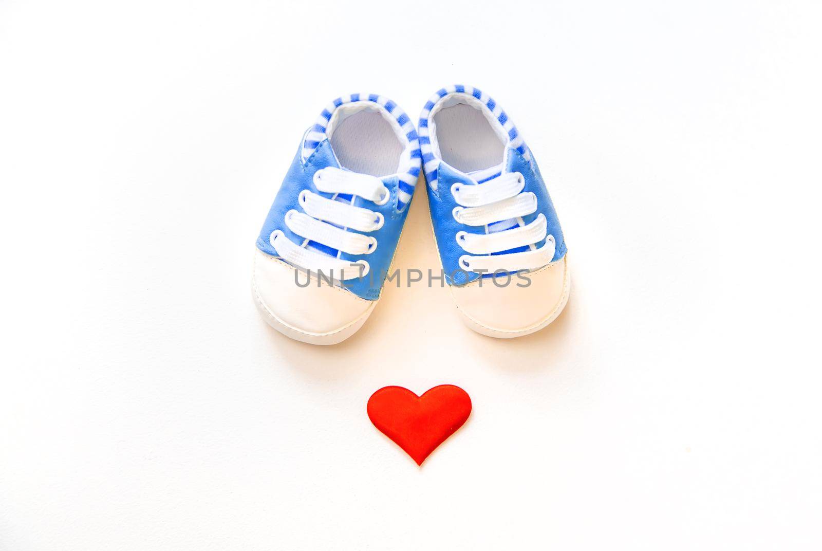 baby booties and heart isolate on a white background. Selective focus.