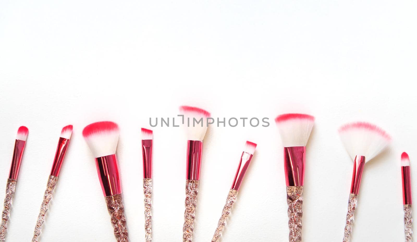 Makeup brushes on a white background. Selective focus.