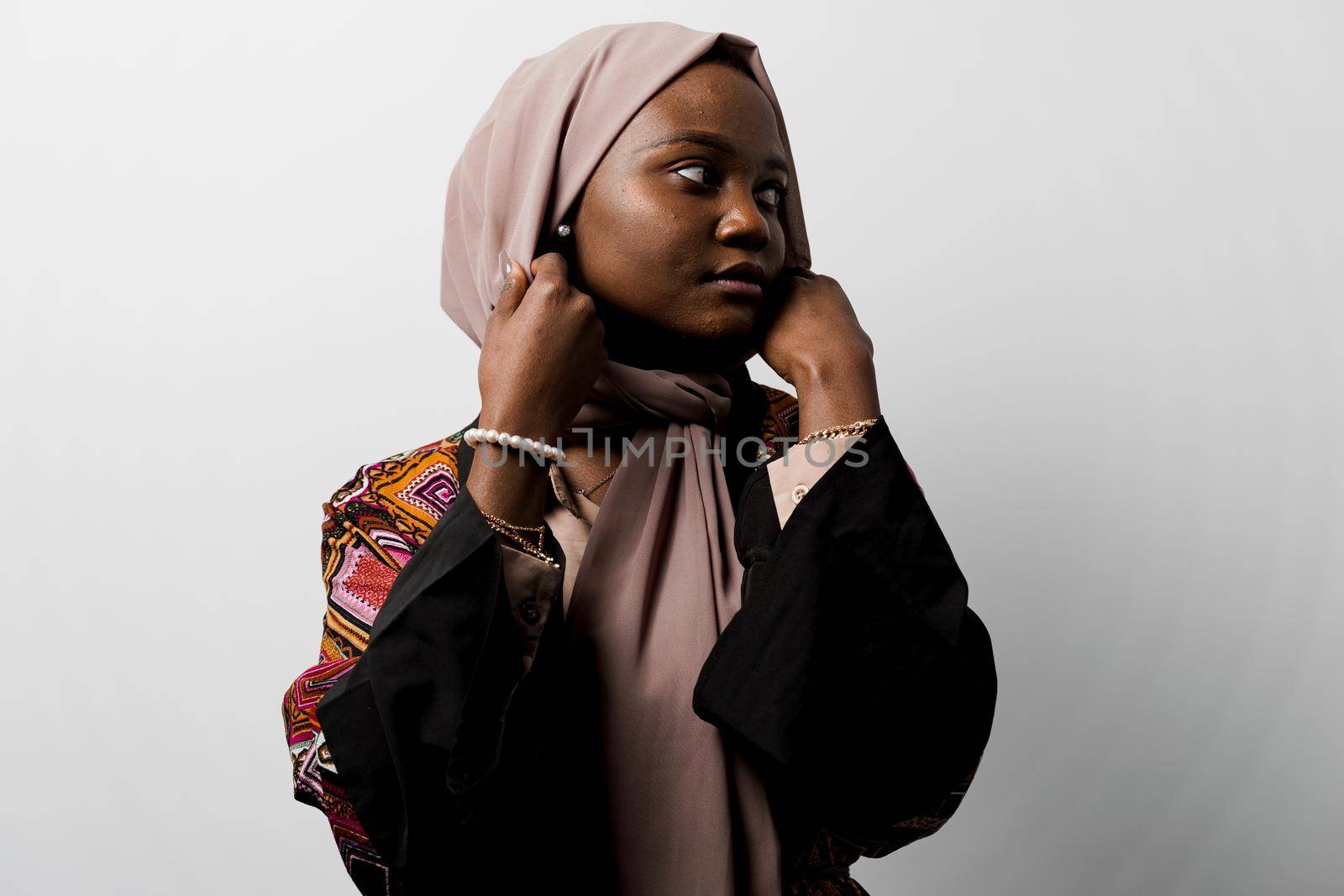 Dreamy black girl weared hijab smile and rejoise on white background. Muslim happy woman posing in studio. Attractive african female.