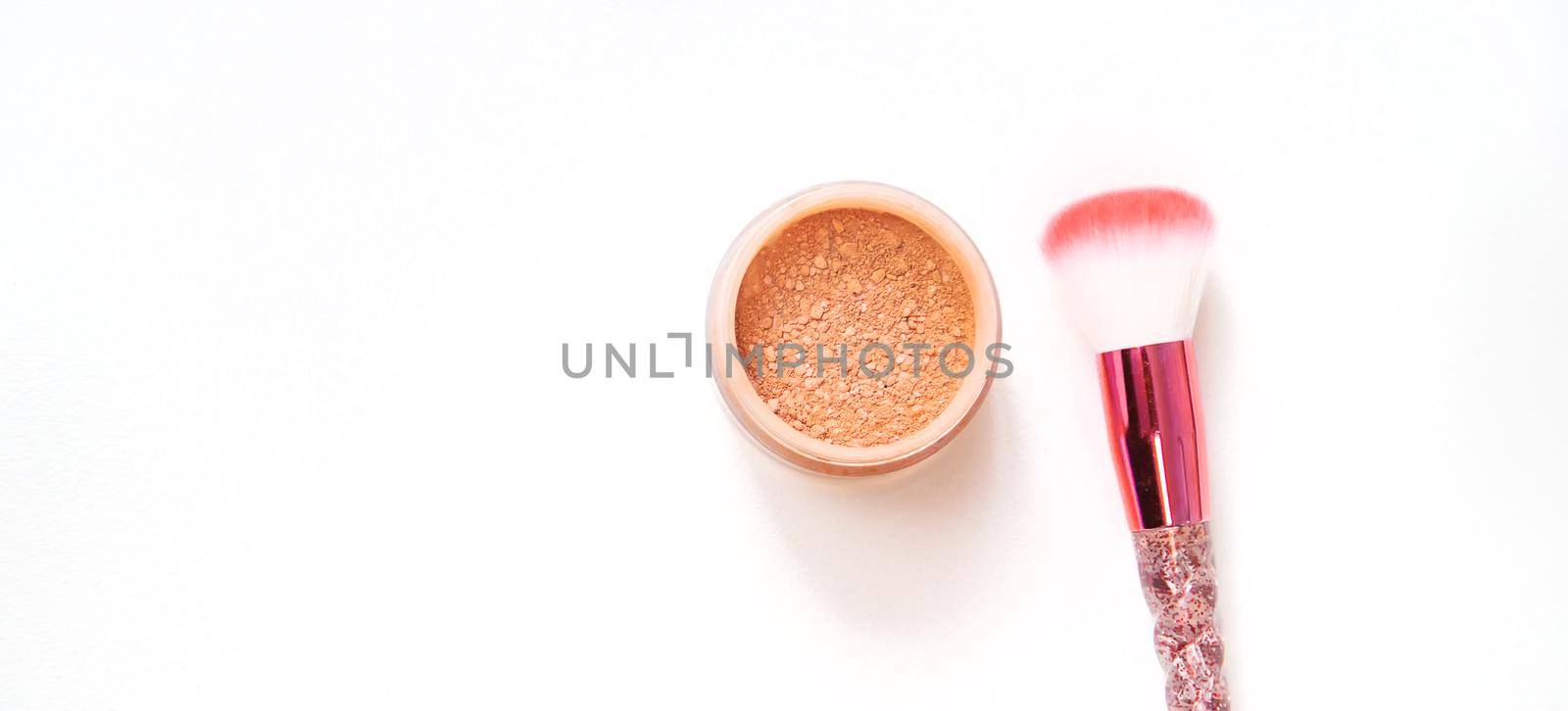 Makeup brushes and powder on a white background. Selective focus. by mila1784