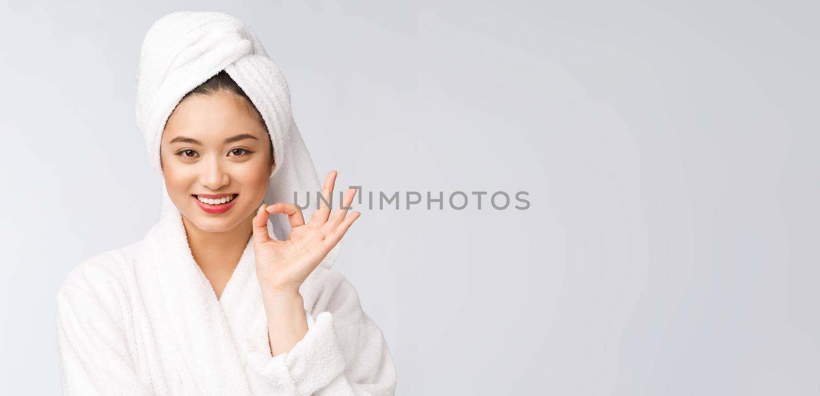 beauty asian woman ok gesture for good facial product. isolated on white background. beauty and fashion concept. by Benzoix