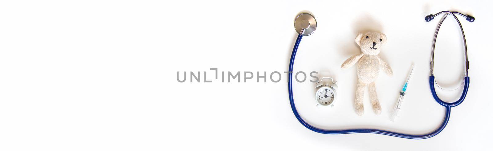 Teddy bear stethoscope and syringe isolate on a white background. Selective focus.