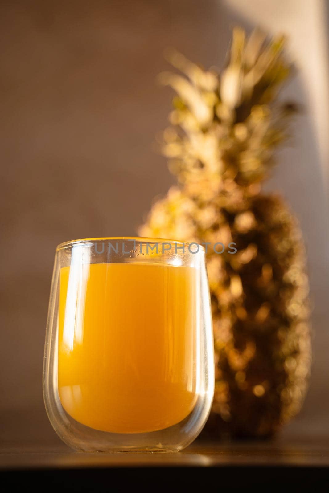 Pineapple fruit and juice in double glass cup. Tropical fruit . Pouring yellow tropical juice into glass.